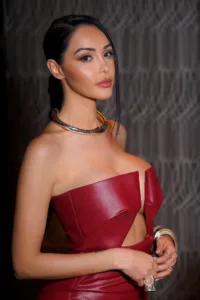 French influencer Nabilla in a red dress and modern jewelry during a fashion shoot, by JG.