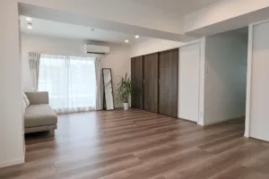 JG Studio's stylish interior, complete with a floor mirror and greenery. A bright, airy studio space characterized by its broad wooden floors.