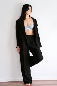 Editorial portrait of model Rioka in an oversized black suit, shot by JG at his Shibuya studio in Tokyo.